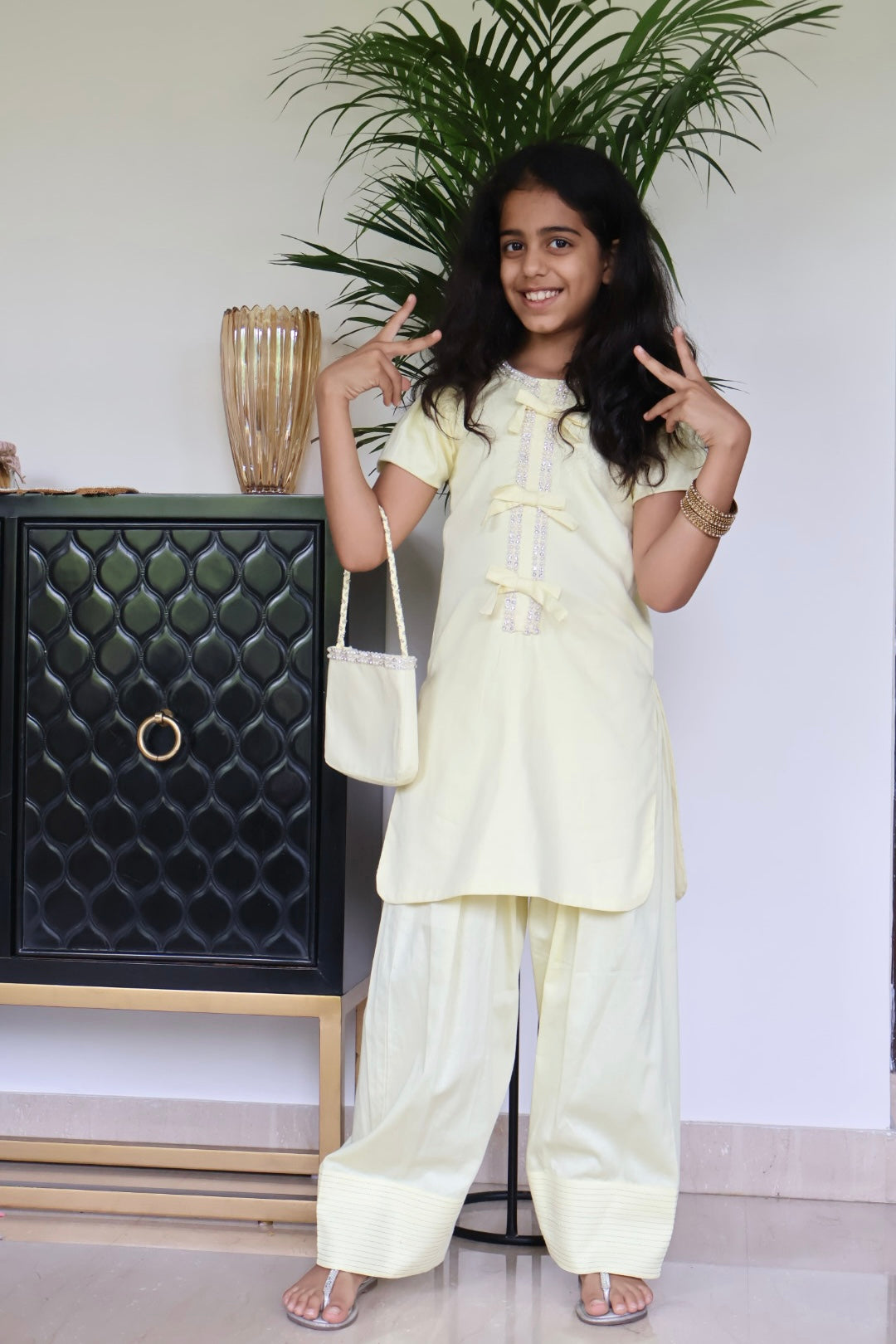 Yellow Farshi salwar suit with matching bag and hair band