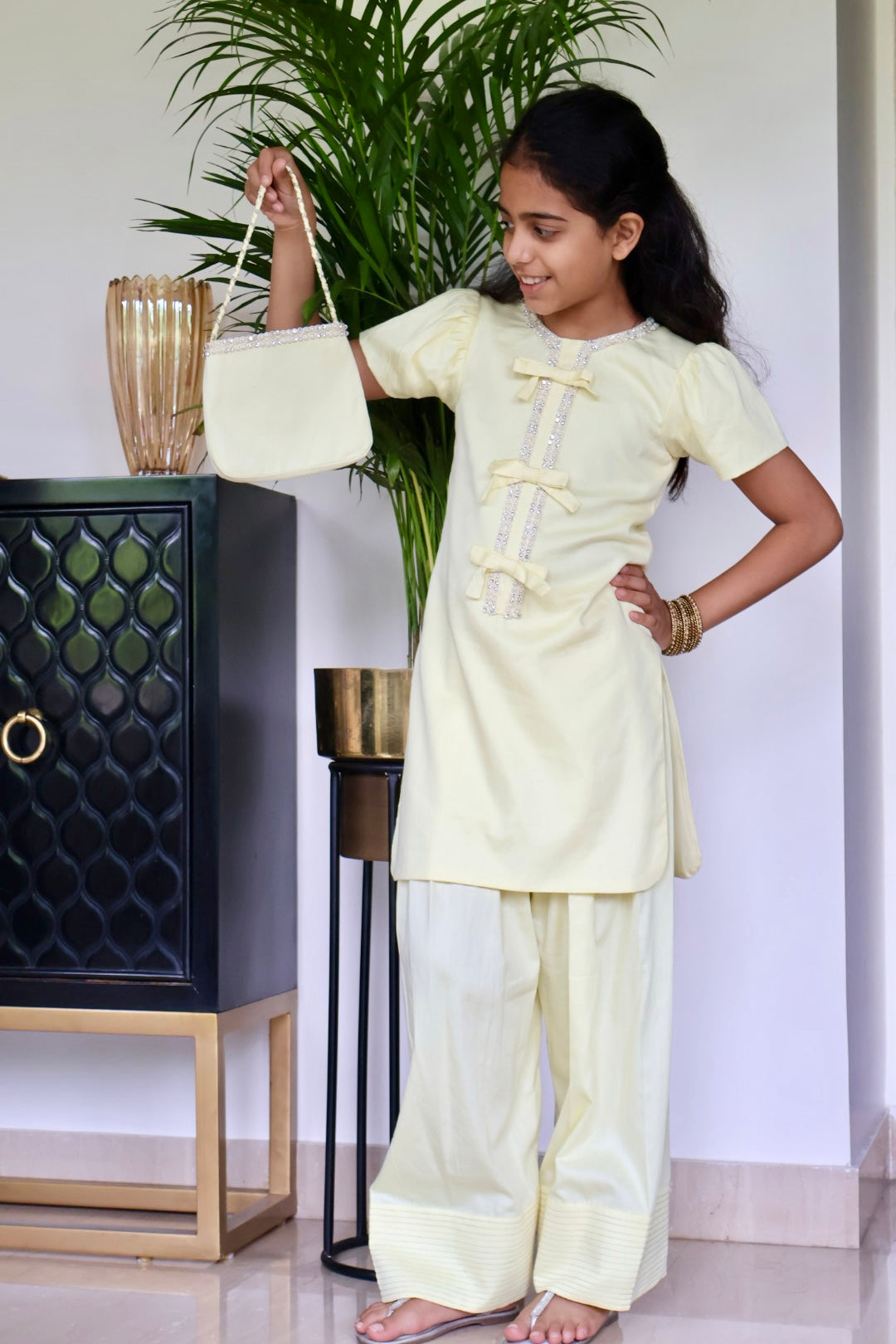 Yellow Farshi salwar suit with matching bag and hair band