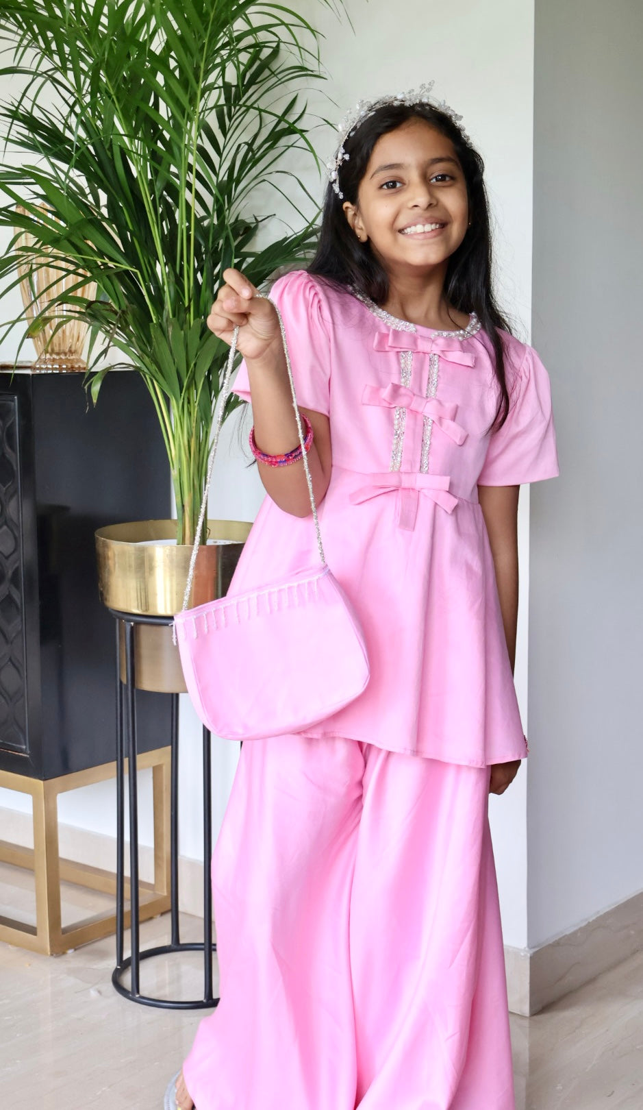 Pink sharara with matching hair band and purse