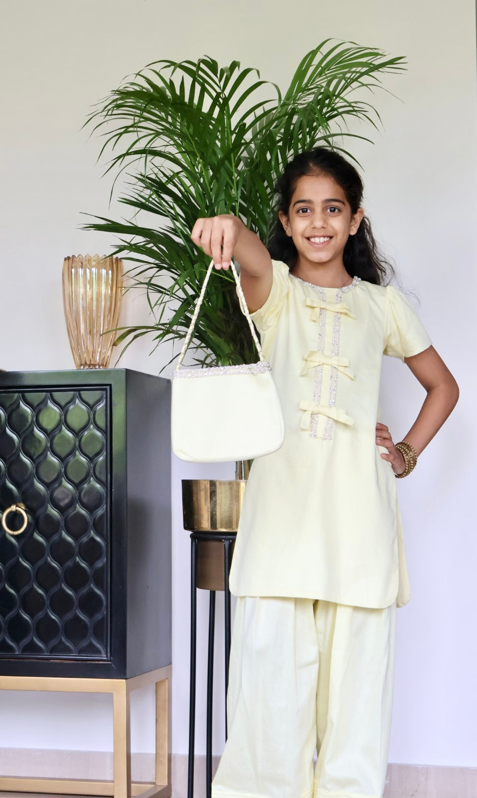 Yellow Farshi salwar suit with matching bag and hair band