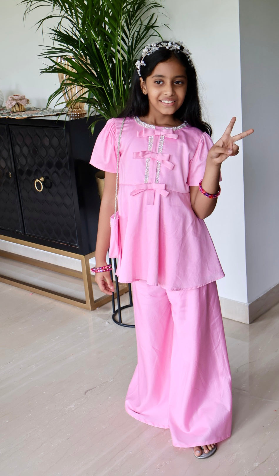 Pink sharara with matching hair band and purse